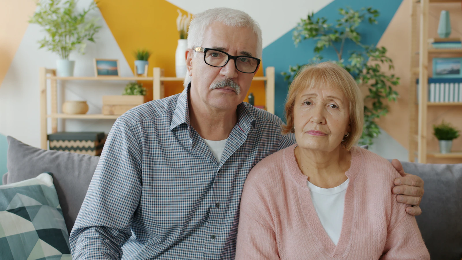 Older couple discussing hair loss treatment decisions at home