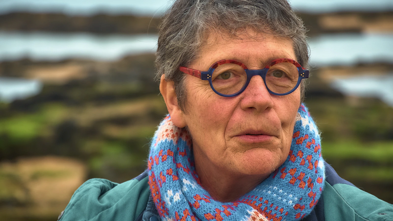 Portrait of an older woman with natural hair visible, representing women experiencing hair volume changes with age