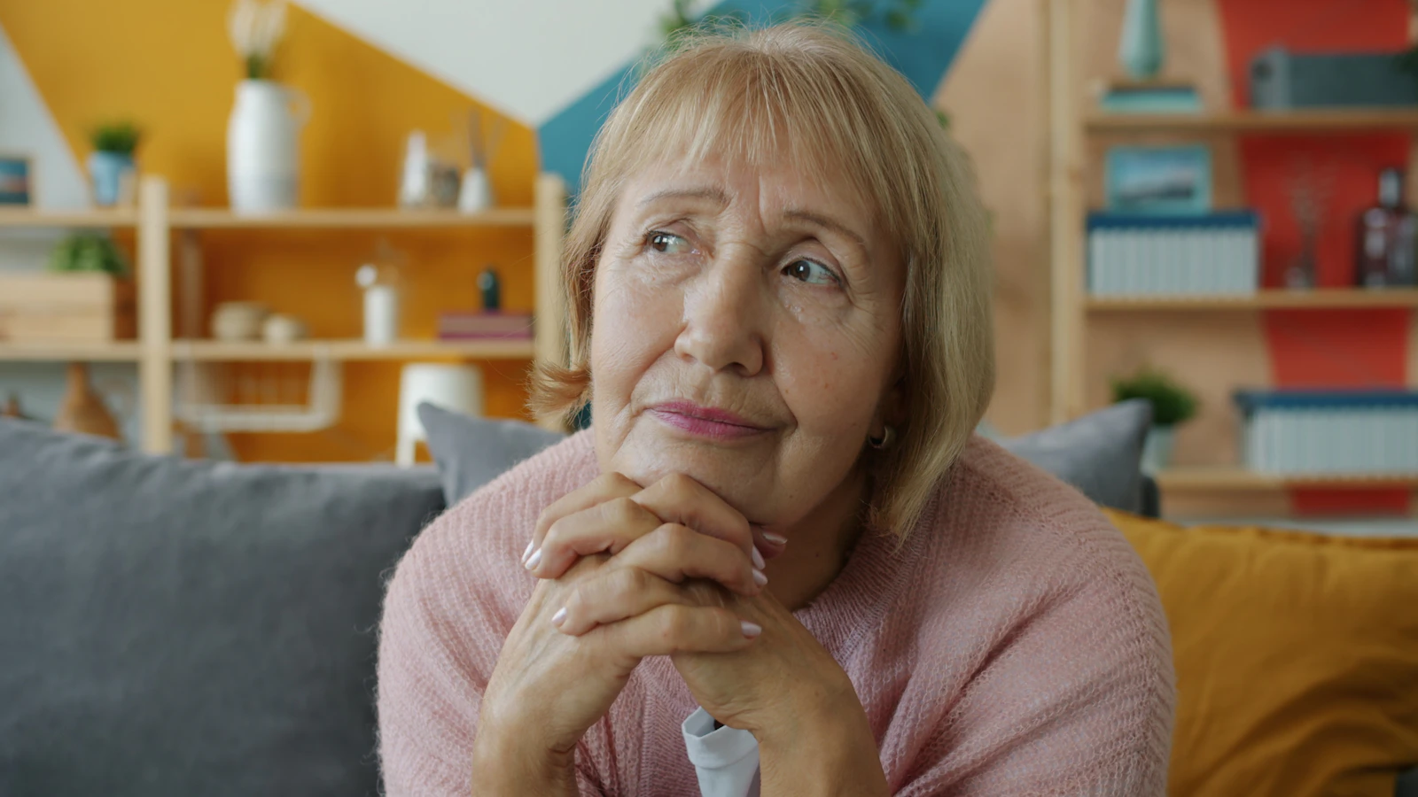 Older woman reflecting on changes in hair volume with age